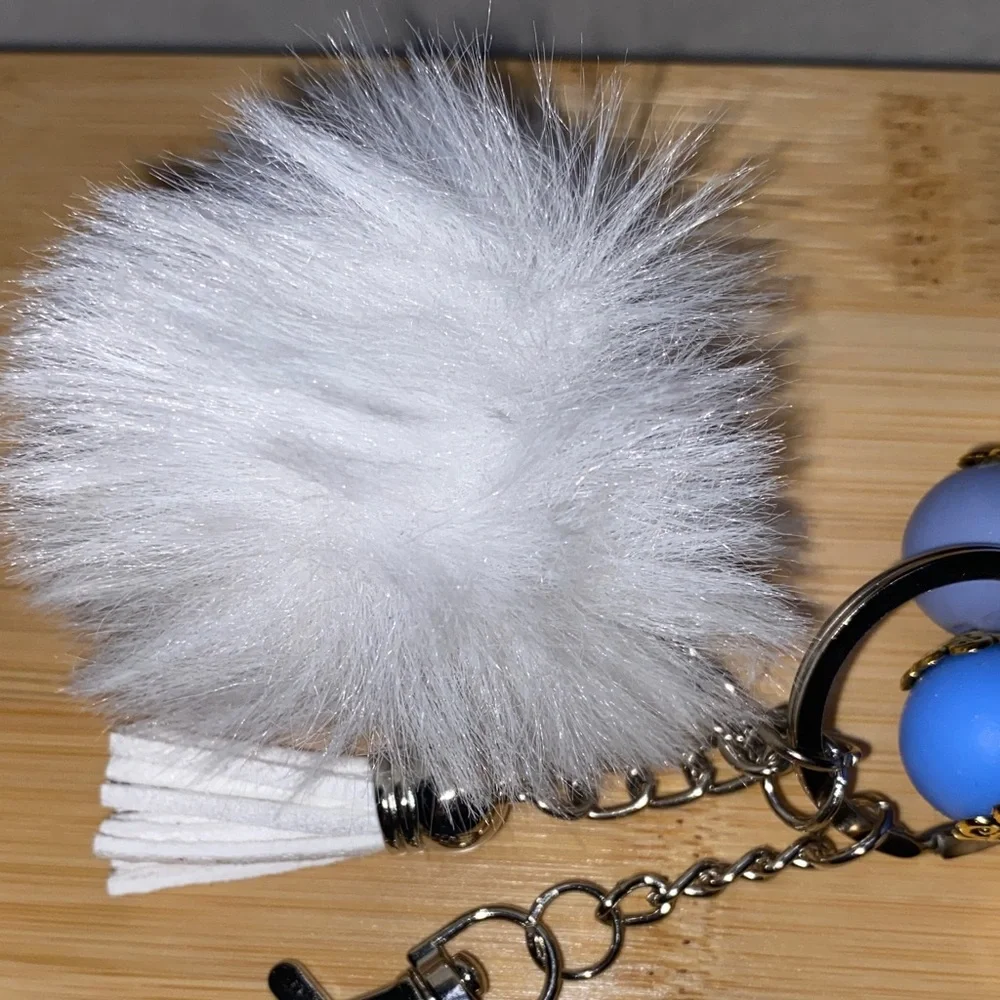 Blue and white bracelet keychain with white pom-pom